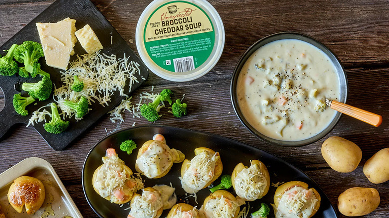Trader Joe's Unexpected Broccoli Cheddar Soup alongside potatoes, broccoli, and cheese