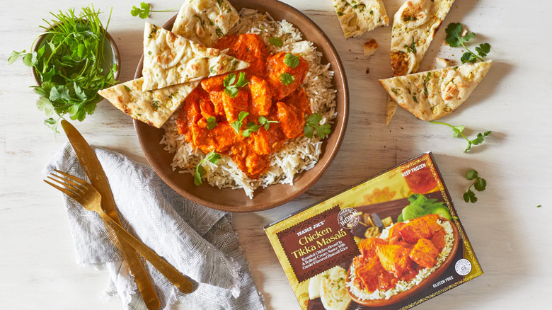 Prepared bowl of Trader Joe's Chicken Tikka Masala﻿ next to the box