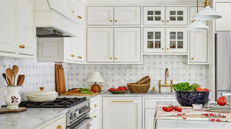 White kitchen cabinets with brass hardware