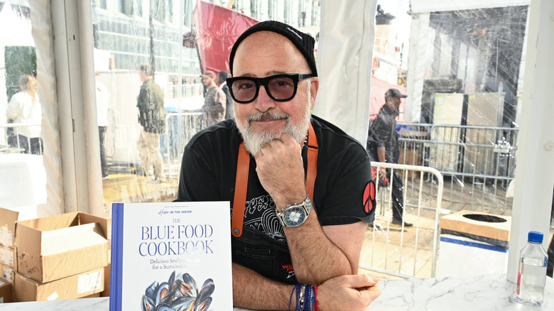 Chef Andrew Zimmern at Grand Tasting, Daytime Edition, posing with his book.