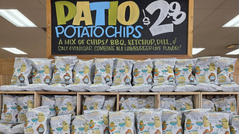 Trader Joe's patio chips sit on a display under a sign