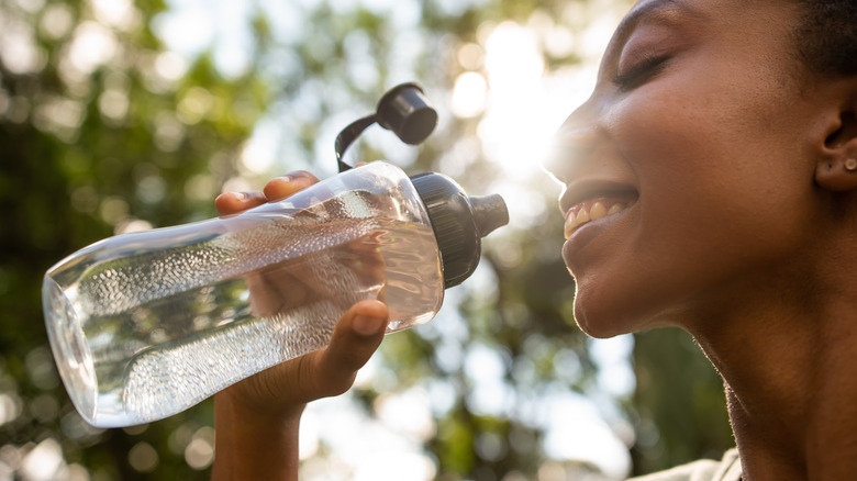 A woman holding a water bottle