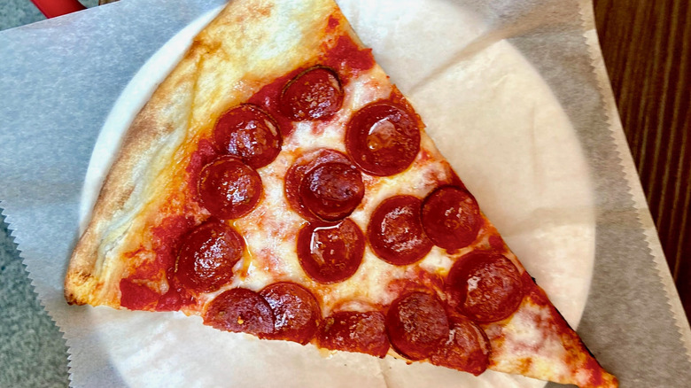 An overhead view shows a slice of pepperoni pizza.