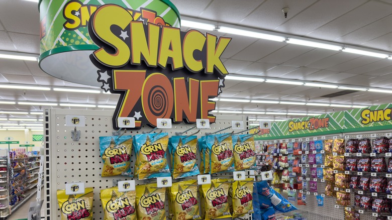 Snack Zone sign at a Dollar Tree with snacks foods in the aisle
