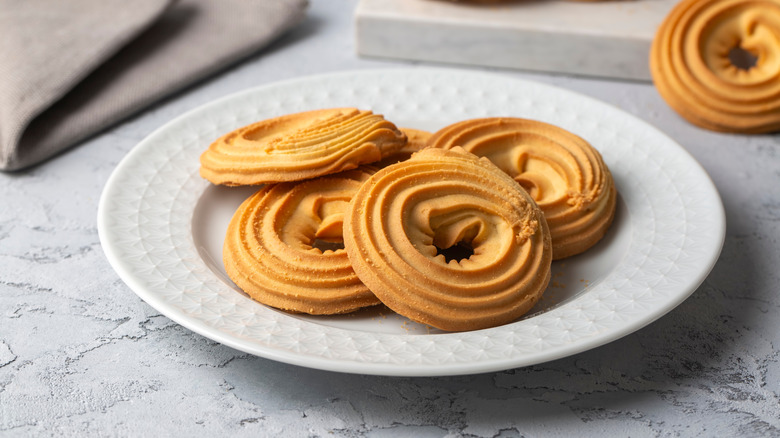 Swirly butter cookies on a white plate