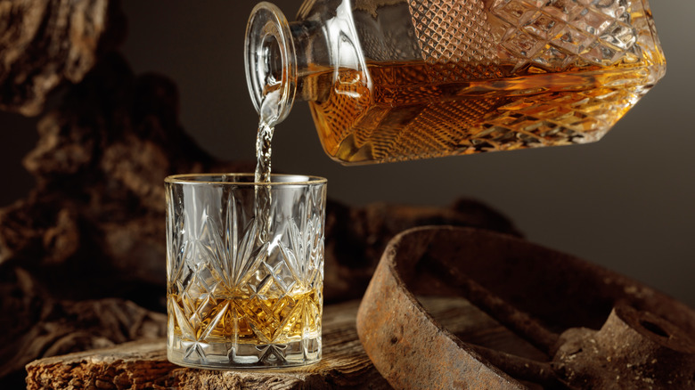 vintage bottle of whiskey poured