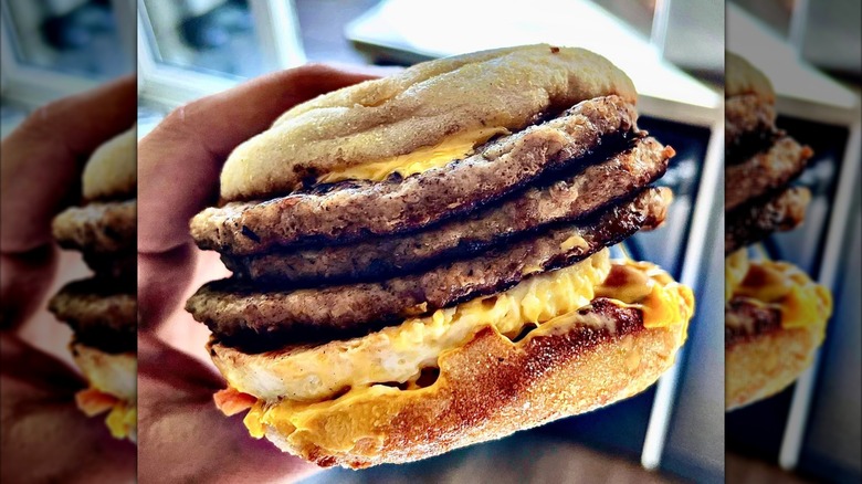 A sausage McMuffin with three sausage patties.