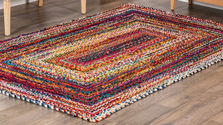 Colorful braided rug on wood floor