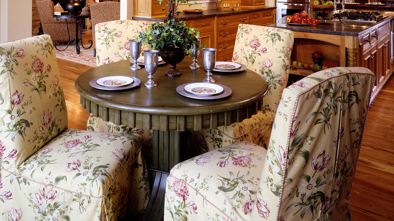 Floral upholstered dining chairs in a predominately wood kitchen