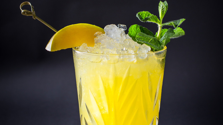 A bright yellow cocktail made with nugget ice.