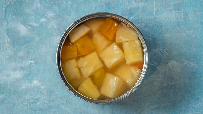 A top-down view of an opened can of diced pineapple