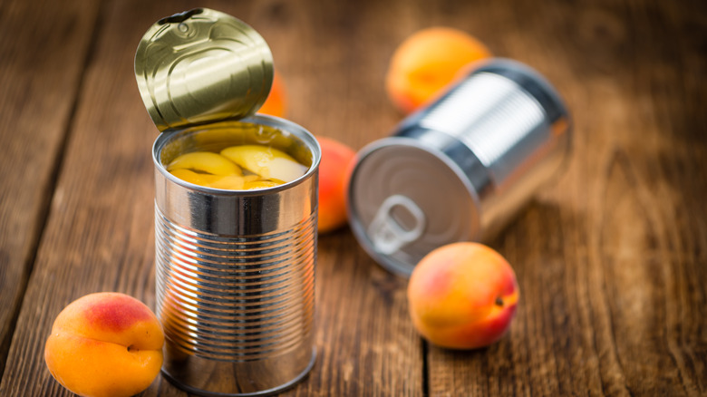 A canning factory moves a conveyor belt of canned pineapple across a factory line