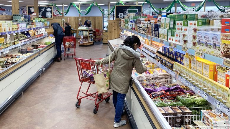 People shopping in the frozen aisle of Trader Joe's