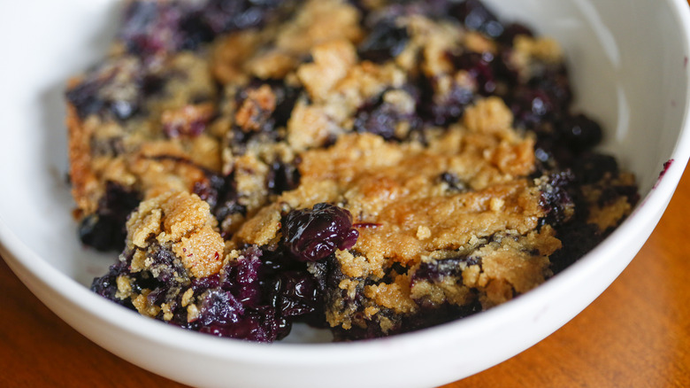 Blueberry cobbler sits in a white bowl