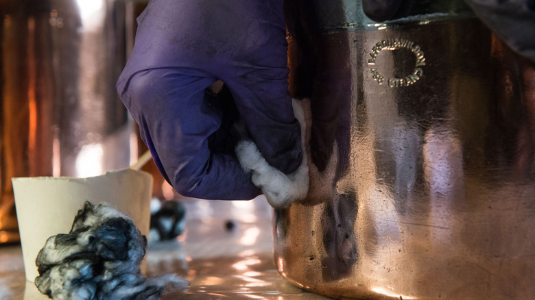 Closeup of hand cleaning copper pot