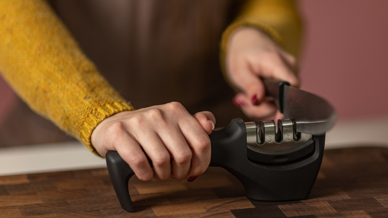 Woman sharpening knife