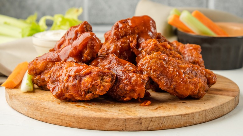 Buffalo chicken wings on wooden board