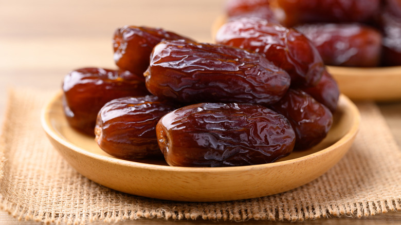 Dried dates in a wooden bowl