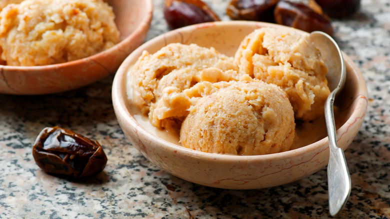 Dates and ice cream sitting on a counter