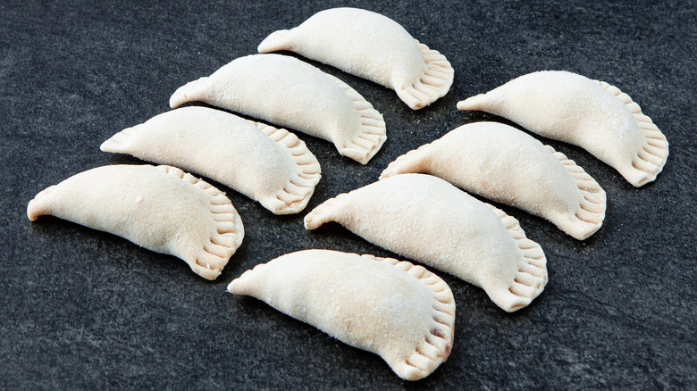 two lines of frozen dumplings on slate table