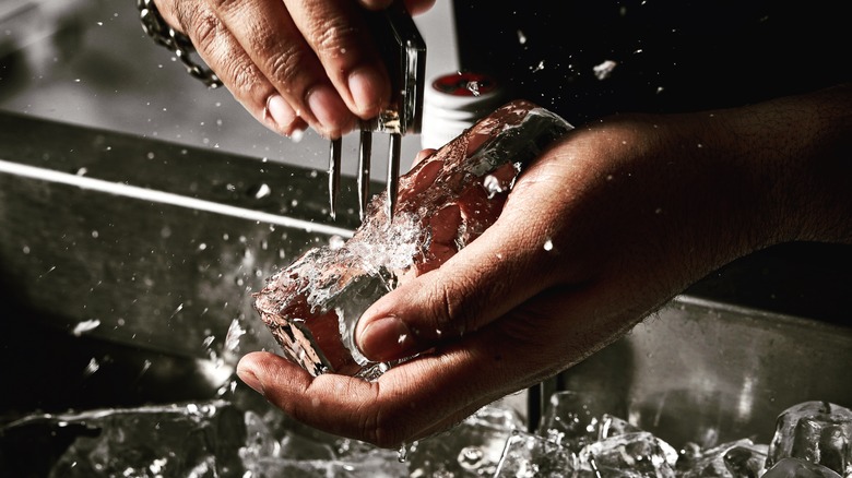 bartender chipping ice block