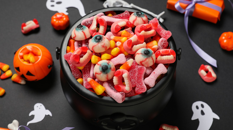 A plastic cauldron full of Halloween candy.