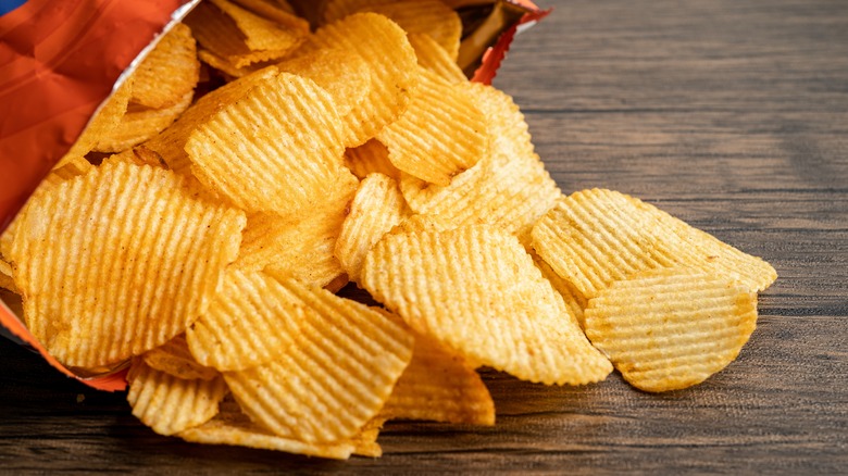 crinkle potato chips spilling from bag