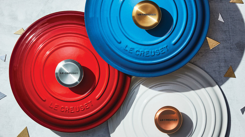 Red, blue, and white Le Creuset lids