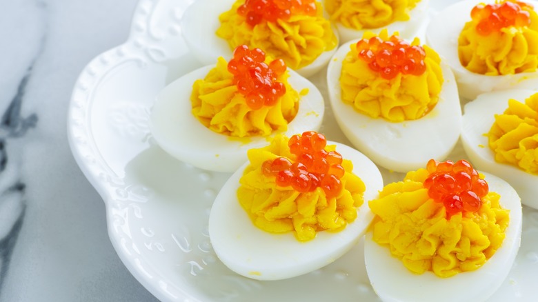 Deviled eggs garnished with orange caviar