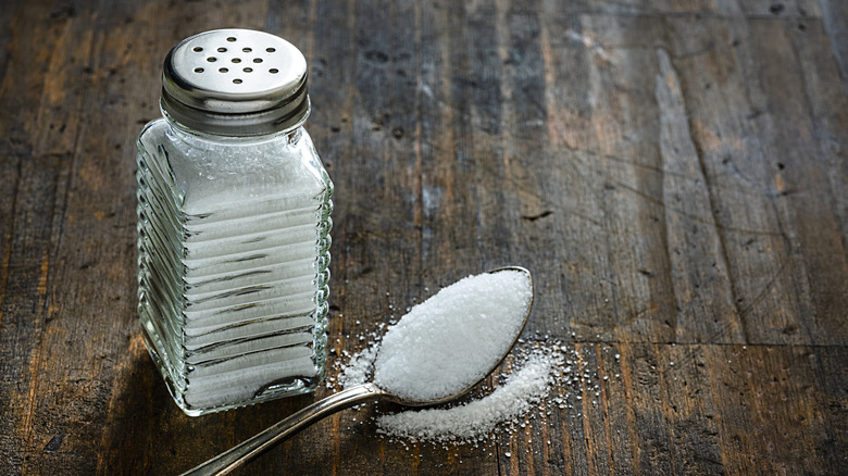 salt shaker and teaspoon of salt