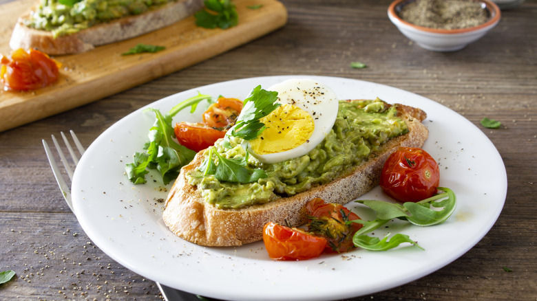 Avocado toast with egg on sourdough bread