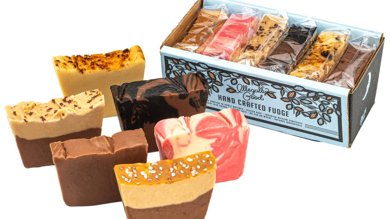 Pieces of Moonshine Fudge sit beside an open box of the treats