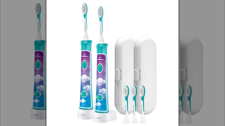 A pair of Philips Sonicare Kids Rechargeable Electric Toothbrushes and their accessories