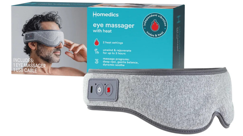 A Homedics eye massager sits next to its box