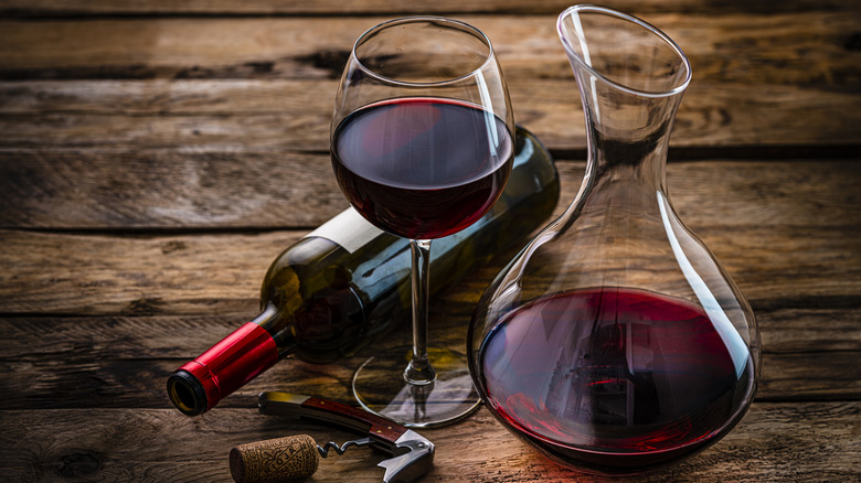 Glass of red wine with bottle and decanter