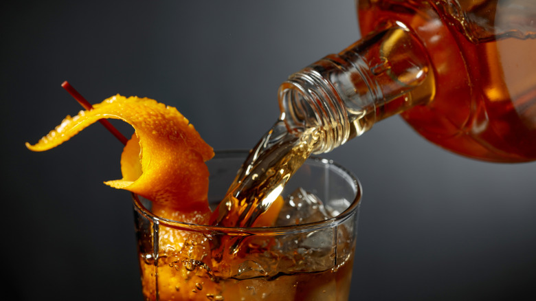 Bourbon pouring into a glass.