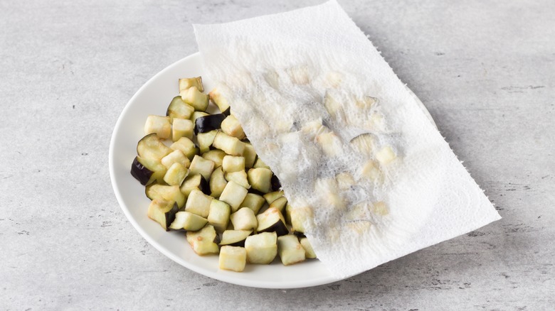 Diced eggplant covered with a paper towel