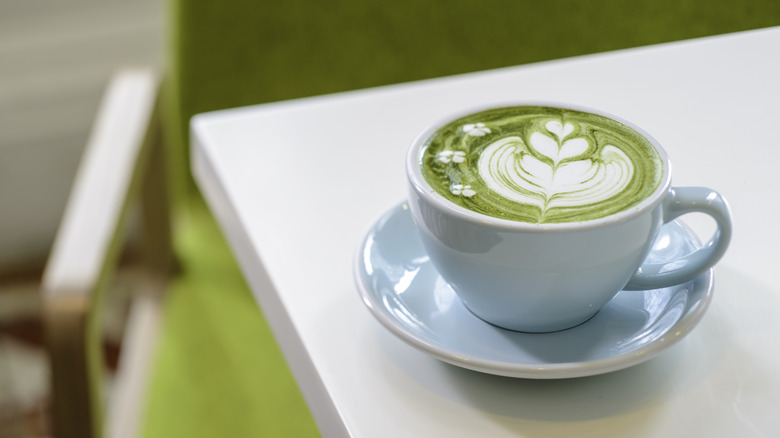 Matcha latte with latte art in a cup on a table
