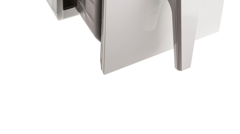 A white air fryer with a basket full of French fries