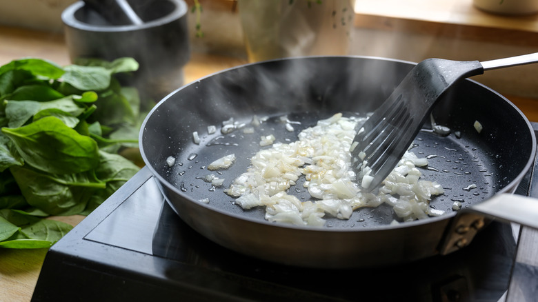raw onions cooking in large skillet