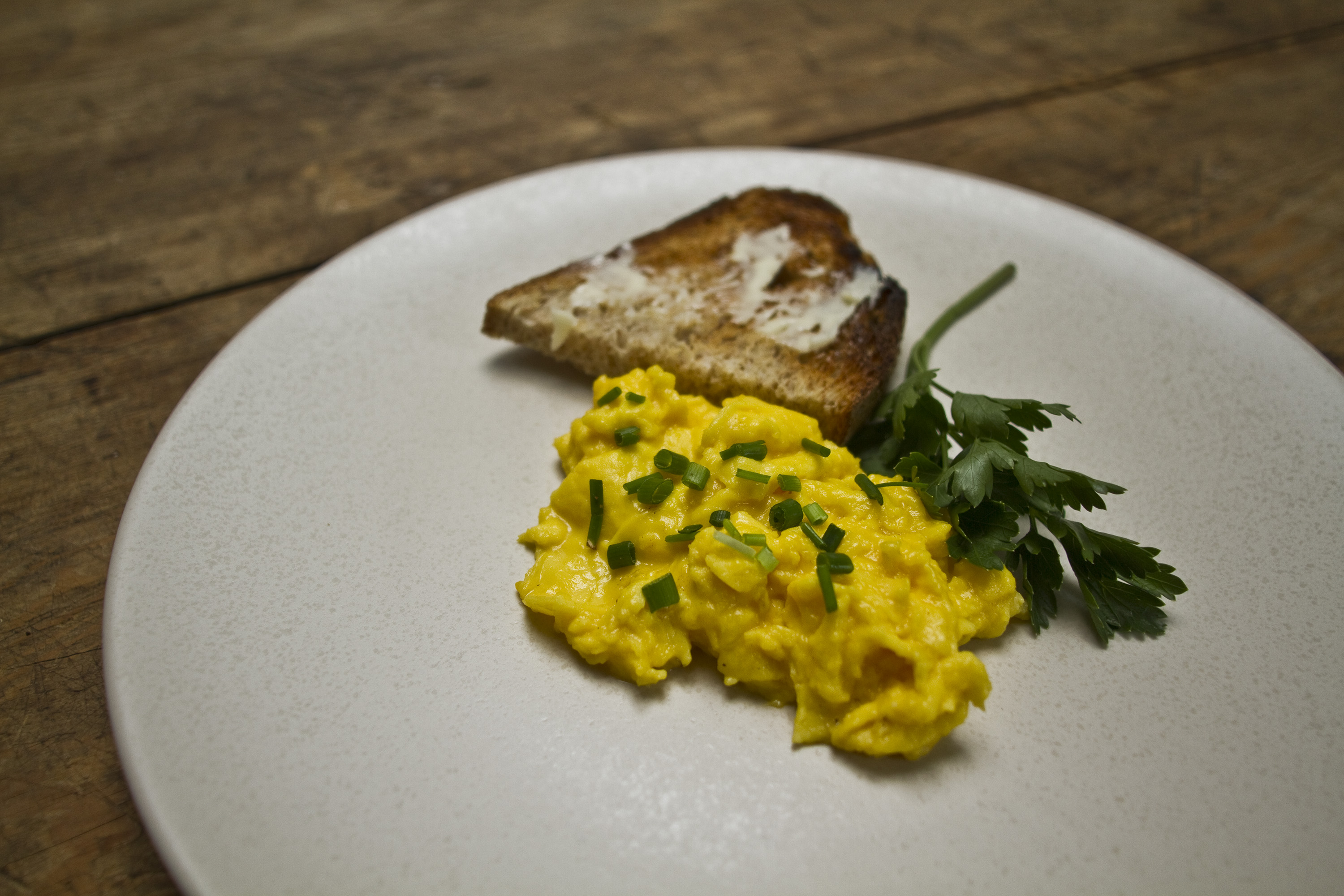 transfer scrambled eggs to plate